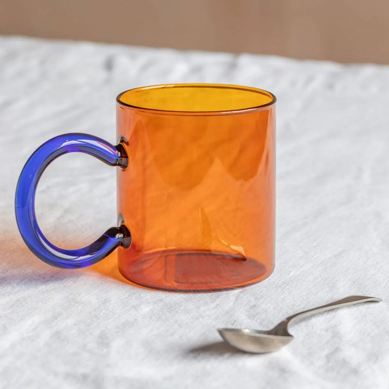 Graham & Green Amber Glass Mug with Blue Handle